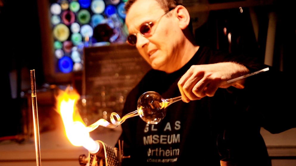 Der Museumsglasbläser Ralf-Marlok arbeitet im Wertheimer Glasmuseum mit der heißen Flamme. | Bild: Glasmuseum Wertheim / Esther Ann