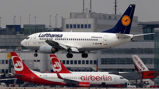 Eine Boeing 737 der Lufthansa fliegt am Donnerstag (20.01.2011) den Flughafen Düsseldorf an. Im Hintergrund stehen Flugzeuge der Fluggesellschaft Air Berlin.  | Bild: picture-alliance/dpa/ Oliver Berg