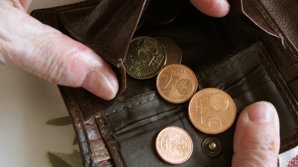 Alte Hände öffnen einen Geldbeutel mit wenigen Münzen darin | Bild: picture-alliance/dpa