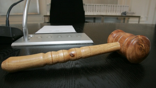 Ein hölzener Hammer liegt auf einer Richterbank. (Symbolbild) | Bild: picture-alliance/dpa