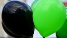 Schwarz-grüne Ballons als Symbol für eine mögliche Koalition | Bild: picture-alliance/dpa | martin Schutt
