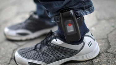 Elektronische Fußfessel am linken Fuß eines Mannes (Symbolbild) | Bild: picture-alliance/dpa