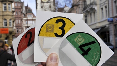 Plaketten, die auf den Schadstoffausstoß von Fahrzeugen hinweisen | Bild: picture-alliance/dpa