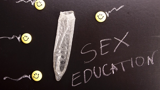 Sybmolbild: Schultafel mit der Aufschrift "Sex education", gezeichneten Spermien und einem Kondom darauf | Bild: Colourbox