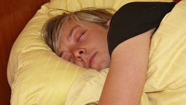 Mann liegt im Bett und schläft | Bild: picture-alliance/dpa