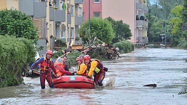 Mitarbeiterinnen der Wasserwacht ziehen am 01.06.2016 in Simbach am Inn (Landkreis Rottal-Inn) ein Schlauchboot durch das Hochwasser. | Bild: picture alliance / abaca | AA