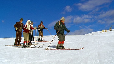 Eine Gruppe Skifahrer auf der Piste mit traditioneller Kleidung und Ausrüstung | Bild: BR