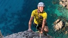 Michi Andres klettert, unter ihm das Meer | Bild: BR/Michael Düchs