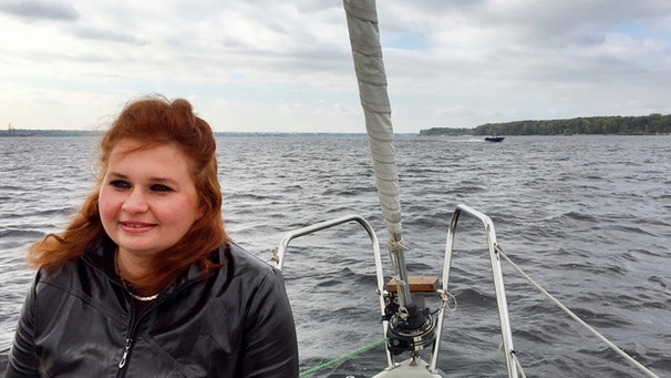 Eine junge Frau sitzt auf einem Schiff. | Bild: WDR