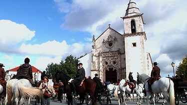 Reiter mit ihren Pferden vor einer Kirche im Dorf Gulga | Bild: BR