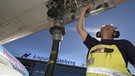 Ein arbeiter am Flughafen Nürnberg bei der Betankung eines Flugzeuges  | Bild: www.airport-nuernberg.de