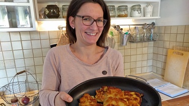 Christina Scheffler mit gebratenen Kartoffelplätzchen in der Pfanne | Bild: BR