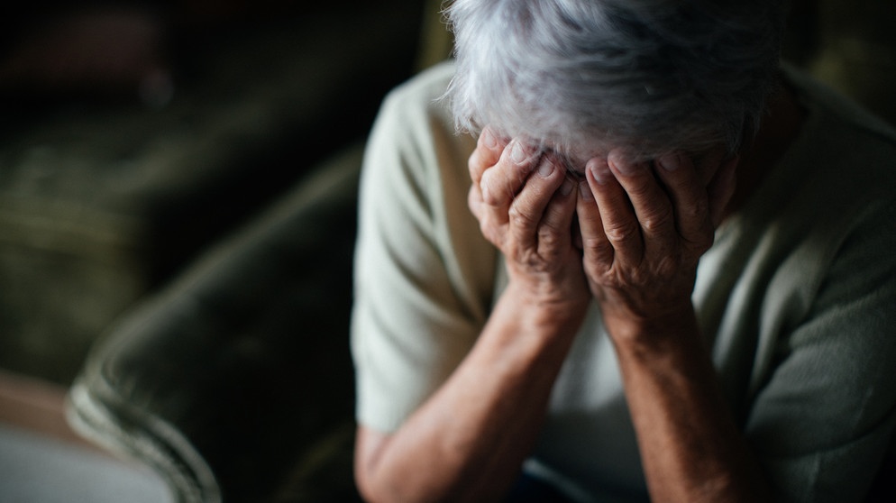 Eine Seniorin hält sich die Hände vors Gesicht. | Bild: BR/Julia Müller