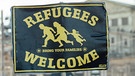 Plakat mit der Aufschrift "Refugees welcome" | Bild: picture-alliance/dpa