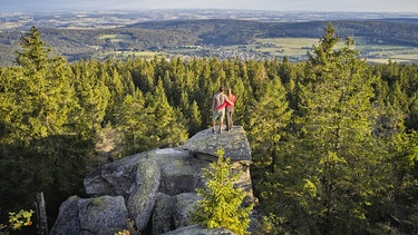 Ein eng umschlungenes Pärchen blickt vom Gipfel des Ochsenkopfs nach Bischofsgrün | Bild: Tourismuszentrale Fichtelgebirge/Florian Trykowski
