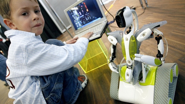 Ein Junge steuert auf der Spielwarenmesse 2007 einen Roboter über einen Computer | Bild: picture-alliance/dpa