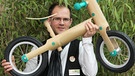 Ein Mann hält ein Laufrad aus Bambus | Bild: picture-alliance/dpa