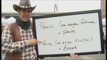 Der Cowboy mit einem Schild und den unterschiedlichen Bedeutungen von Pause im Englischen | Bild: Bayerischer Rundfunk