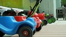 Dreiräder und Bobby Cars stehen vor einem Kindergarten | Bild: Bayerischer Rundfunk 2023