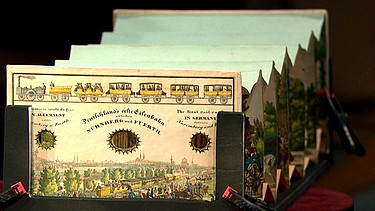 Diorama. Wie eine Illusionsmaschine im Taschenformat fungiert um 1845 dieses Diorama, das den Betrachter scheinbar zum Zeugen der Einweihung von Deutschlands erster Eisenbahnstrecke machte. Geschätzter Wert: 1.500 bis 1.800 Euro  | Bild: Bayerischer Rundfunk