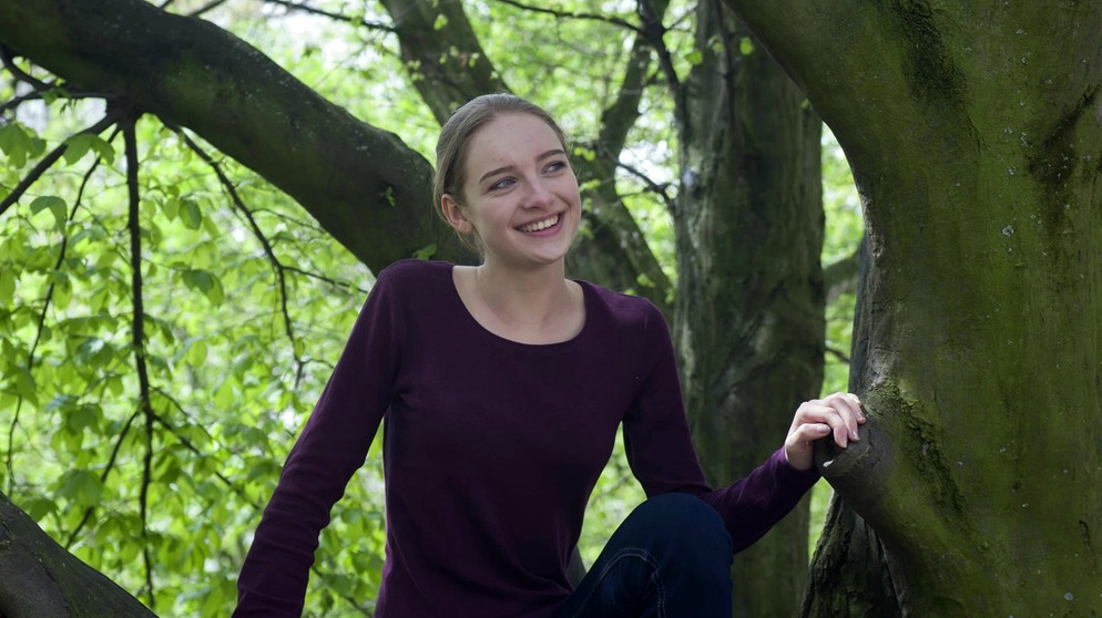 Christine sitzt auf einem Baum | Bild: Bayerischer Rundfunk