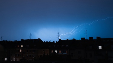 Ein Blitz über den Dächern der Stadt. | Bild: BR/Julia Müller
