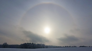 Eine Halo-Erscheinung der Sonne ist über der winterlichen Landschaft im Landkreis Oder-Spree im Osten des Bundeslandes Brandenburg. | Bild: dpa-Bildfunk/Patrick Pleul