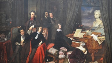 Franz Liszt sitzt umgeben von vielen jungen Pariser Künstlern am Klavier. Gemälde von Joseph Danhauser um 1840. | Bild: picture alliance/Heritage Images