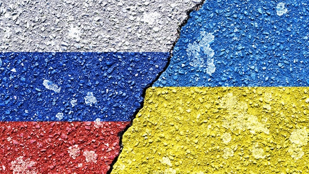 Symbolbild für den Russland-Ukraine-Krieg: Die Fahnen von Russland und der Ukraine mit einem Riss. | Bild: picture alliance / CHROMORANGE | Christian Ohde