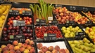 Die Obsttheke im Bio-Supermarkt: Es liegen Pfirsiche, Pflaumen, Birnen, Rhabarber und Äpfel in der Auslage. | Bild: BR | Theresa Höpfl