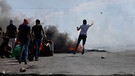 14.05.2021, Palästinensische Autonomiegebiete, Nablus: Ein Demonstrant schleudert Steine auf israelische Soldaten während eines anti-israelischen Protests am Huwwara-Kontrollpunkt in der Nähe der Westbank-Stadt Nablus. Foto: XinHua/dpa +++ dpa-Bildfunk +++ | Bild: dpa-Bildfunk