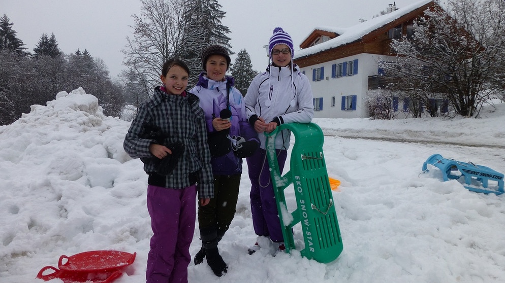 Drei Workshop-Schüler mit Schlitten vor der Jugendherberge in Oberstdorf | Bild: BR
