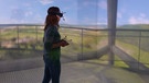 Eine Frau trägt eine VR-Brille, mit der ein hoher Aussichtstur simuliert wird. Dies ist auch auf einer Wand im Hintergrund zu sehen. | Bild: Martin Herrmann / Uni Würzburg