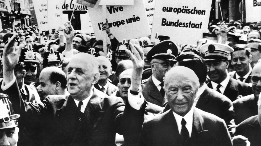 Gestenreich bedankt sich Frankreichs Präsident Charles de Gaulle (links) bei seinem Bonn-Besuch am 5.9.1962 für den Jubel der Bonner Bürger. Sein Gastgeber ist Kanzler Konrad Adenauer (r.) | Bild: picture-alliance/dpa