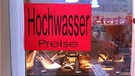 Manche versuchen es mit Humor: Ein Geschäft in Regensburg verlangt "Hochwasser-Preise". | Bild: privat/BR