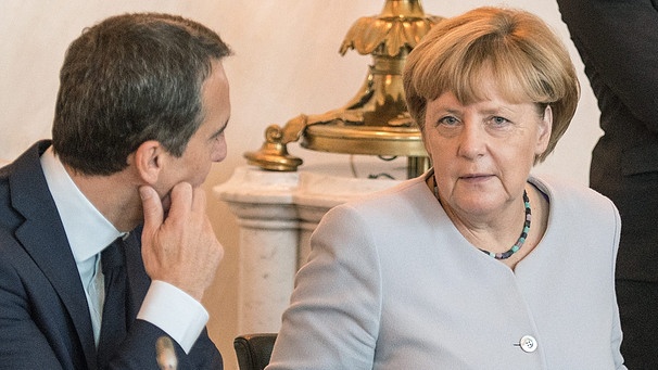 Der österreichische Kanzler Christian Kern im Gespräch mit Angela Merkel während einem Flüchtlingsgipfel in Wien | Bild: dpa/Christian Bruna