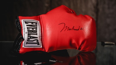 Seinen roten Boxhandschuh hatte Box-Legende Muhammad Ali Mitte der 1970er-Jahre für Fritz Egner signiert. Jetzt wird er zugunsten von Sternstunden versteigert. | Bild: BR / Vera Johannsen