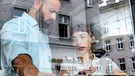 Dr. Pielach (Ruth Brauer-Kvam, rechts) vertraut Dr. Hoffmann (Anton Noori) im Café ein schwerwiegendes Geheimnis an. | Bild: BR/Lotus-Film/ORF/Petro Domenigg