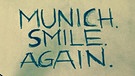Plakat: Munich. Smile. Again | Bild: facebook.com/ BlackRebellMotorSoccerClub