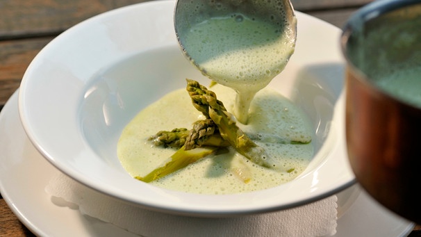 Schöpflöffel mit feiner schaumiger Suppe, dazu grüne Spargelspitzen | Bild: mauritius images / Hubertus Blume / Alamy / Alamy Stock Photos