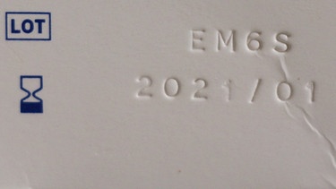 Neben einer Sanduhr ist auf einer Verpackung das Mindesthaltbarkeitsdatum 2021/01 aufgedruckt.  | Bild: BR