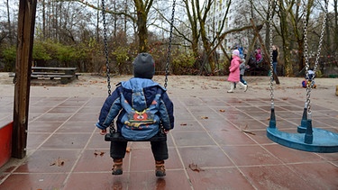 Kind sitzt alleine auf einer Schaukel | Bild: picture-alliance/dpa
