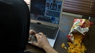 Jugendlicher sitzt vor Computerspiel, daneben eine Tüte Chips | Bild: picture-alliance/dpa