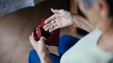 Eine Seniorin mit einem Geldbeutel in der Hand. | Bild: BR/Julia Müller