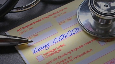 Auf einem Krankenschein steht die Diagnos Long Covid. | Bild: picture alliance / SVEN SIMON | Frank Hoermann