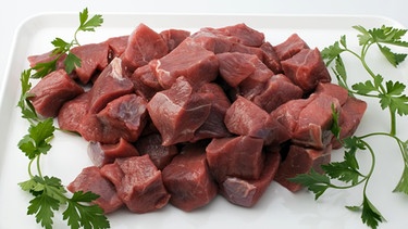 In Würfel geschnittenes rohes Rindfleisch und Petersilie | Bild: picture-alliance/dpa