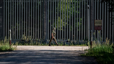 Ein Soldat läuft am Grenzzaun auf der polnischen Seite zu Belarus entlang. An der EUAußengrenze
zum Nachbarland Belarus hat Polen einen 5,5 Meter hohen Metallzaun mit
Bewegungsmeldern und Nachtsichtkameras errichtet.
| Bild: picture alliance / dpa / Fabian Sommer