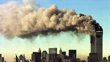 Die rauchenden Zwillingstürme des World Trade Centers, nachdem zwei Flugzeuge in sie hineingeflogen waren.  | Bild: picture-alliance/dpa