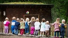 Mehrere Kinder stehen an einem Zaun. | Bild: stock.adobe.com/Anna Ritter