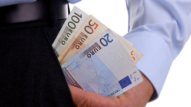 Mann zieht Geldbündel aus der Hosentasche | Bild: picture-alliance/dpa